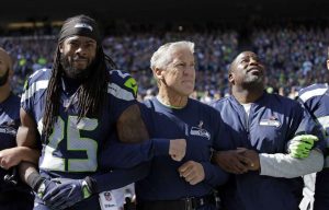 richard sherman and pete carroll arm in arm
