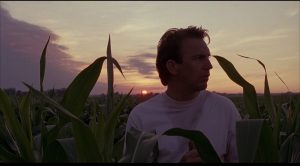 kevin costner in a corn field from the movie "field of dreams"