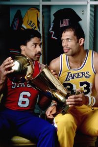 dr. j and kareem stare each other down over the nba finals trophy