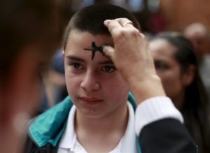 boy receiving ashes on forehead for ash wednesday