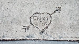 candy + jack written in a heaart with an arrow thru it on cement--vocabulario en inglés